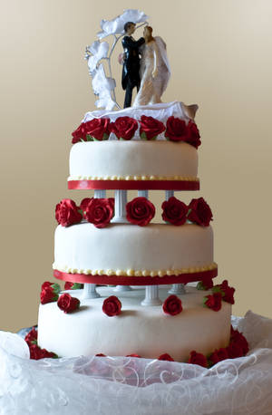 Caption: A Bride And Groom Topped Wedding Cake Wallpaper