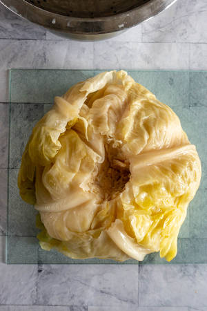 Caption: A Close-up Shot Of Sour, Green Lemons On Wooden Table Wallpaper