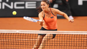 Caption: Agnieszka Radwanska Engrossed In A Tennis Match Wallpaper