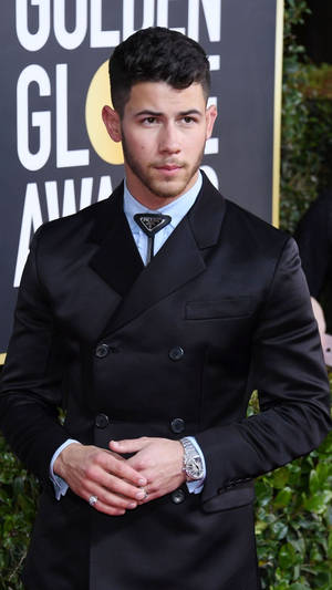 Caption: Charismatic Nick Jonas Slays In Chic Black Suit Wallpaper