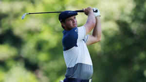 Caption: Chris Kirk Focused On Achieving The Perfect Swing During A Golf Match. Wallpaper