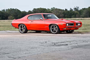 Caption: Classic Splendor: Pontiac Gto In Oceanic Blue Wallpaper