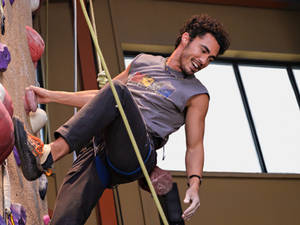 Caption: Darren Barnet Showing Climbing Skills. Wallpaper