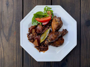 Caption: Exquisite Coq Au Vin Served On Sleek White Hexagonal Plate Wallpaper