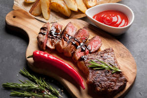 Caption: Fresh Grilled Meat Striploin With Spicy Chili Sauce Wallpaper