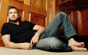 Caption: Gerard Butler Striking A Pose For A Magazine Shoot Wallpaper