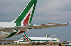 Caption: Glimpse Of Alitalia's Rudder In Flight Wallpaper