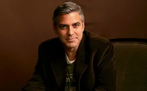 Caption: Hollywood Actor George Clooney Posing In A Casual Suit Wallpaper