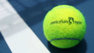 Caption: Intense Focus: Close Shot Of Tennis Ball At Australian Open Wallpaper