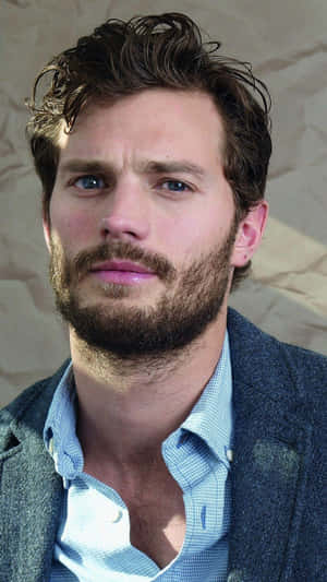 Caption: Jamie Dornan Exuding Casual Elegance Wallpaper