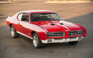 Caption: Majestic Pontiac Gto In Sunny Atmosphere Wallpaper