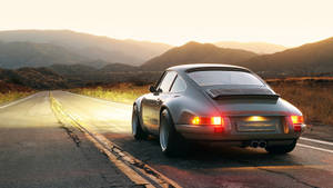 Caption: Majestic Singer Porsche 911 Illuminated In The Night Wallpaper