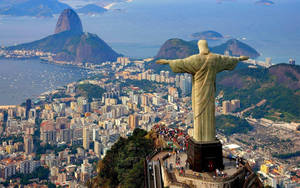 Caption: Majestic View Of Christ The Redeemer Overlooking South America Wallpaper