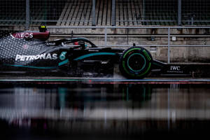 Caption: Mercedes Amg Petronas F1 Racing Car On Track Wallpaper