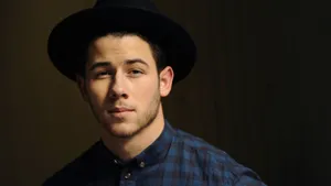 Caption: Nick Jonas Exudes Coolness In A Checkered Polo. Wallpaper