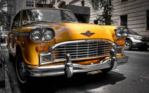 Caption: Relic Of An Era: Vintage Checker Taxi Cab Wallpaper