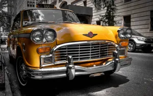 Caption: Relic Of An Era: Vintage Checker Taxi Cab Wallpaper
