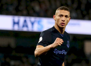 Caption: Richarlison De Andrade Triumphantly Clenching His Fist After A Successful Game Wallpaper