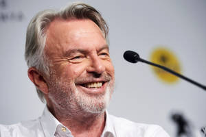 Caption: Sam Neill At 2019 Press Conference Wallpaper