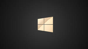 Caption: Shimmering Golden Windows Logo On A Dark Background Wallpaper