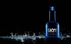 Caption: Skyy Vodka Bottle Making A Splash Wallpaper