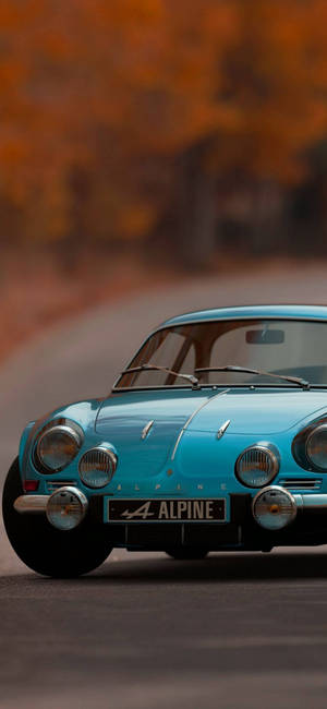 Caption: Sleek Blue Alpine A110: The Ultimate Iphone Car Companion Wallpaper