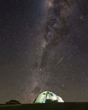 Caption: Spectacular Meteor Showering The Night Sky Wallpaper