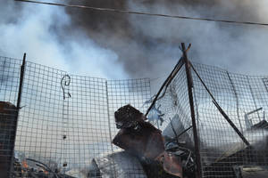 Caption: Vibrant Landscape Of Nasiriyah, Iraq With Looming Piles Of Scrap Metal Wallpaper