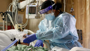 Caring Nurse Assisting Patient On Hospital Bed Wallpaper