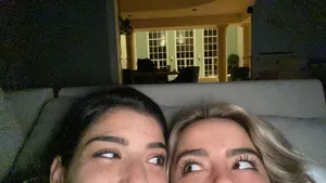 Charli And Addison Lying On A Couch Wallpaper