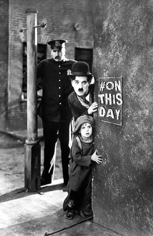 Charlie Chaplin And Kid Peeking Wallpaper