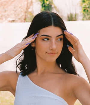 Charlie Damelio Posing In A Sultry Photoshoot Wallpaper