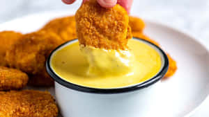 Chicken Nugget Dippingin Mustard Sauce Wallpaper