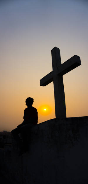 Christian Cross Against Sunset Horizon Wallpaper