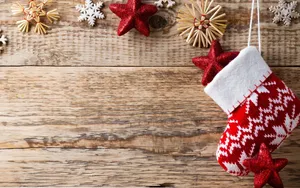 Christmas Stocking Hanging On A Wooden Background Wallpaper