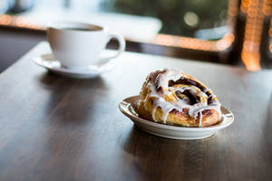 Cinnamon Bun To Go With Coffee Wallpaper