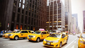 Cityscape With A Fleet Of Taxis Wallpaper