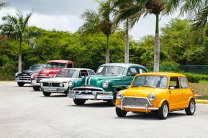 Classic Cars Lined Up In Parking Lot Wallpaper