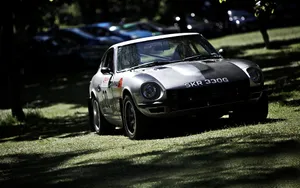 Classic Datsun Speeding On Open Road Wallpaper