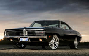 Classic Muscle Car Under Stormy Skies Wallpaper