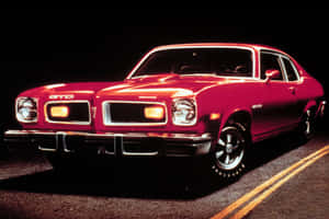 Classic Pontiac Gto Against A Bright Red Sunset Wallpaper