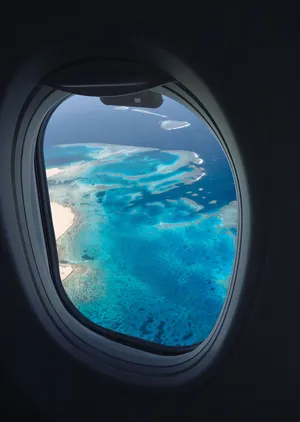 Clear Ocean Shot From A Plane Window Wallpaper