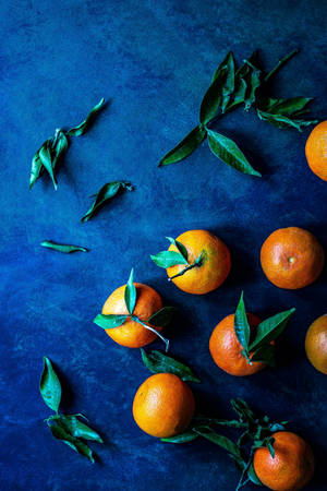 Clementine Fruits Creative Flat Lay Blue Background Wallpaper