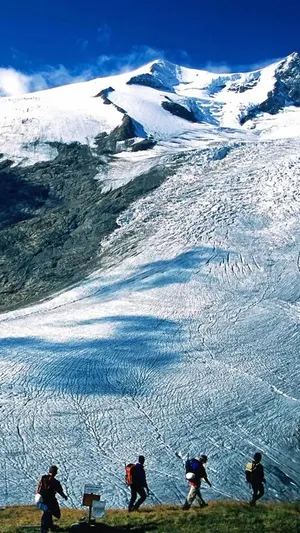 Climbing A Snowy Mountain Slope Wallpaper