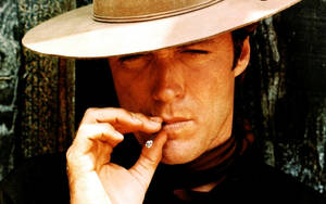 Clint Eastwood Cowboy Hat Smoking A Cigarette Wallpaper