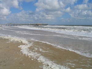 Cloudy Sky Above Virginia Beach Shoreline Wallpaper