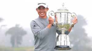 Collin Morikawa Holding His Pga Trophy Triumphantly Wallpaper