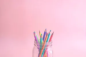 Color Pencils In Jar With Pastel Pink Color Background Wallpaper