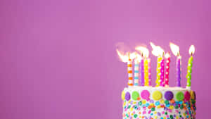 Colorful Birthday Cakewith Lit Candles Wallpaper