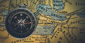 Compass On Top Of A Map Wallpaper